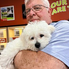 A happy Petland Summerville customer holding a puppy