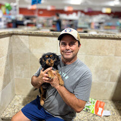 A Petland Summerville customer holding a puppy